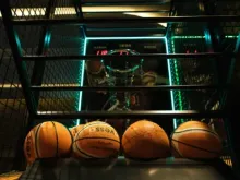Players competing in a basketball game on an indoor court