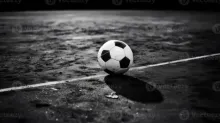 A football and a marble shown together for size comparison