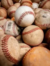 A baseball bat and baseball used in the sport of baseball