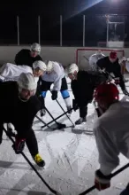 Ice hockey players competing on an ice rink