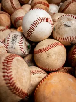 A baseball bat and baseball used in the sport of baseball